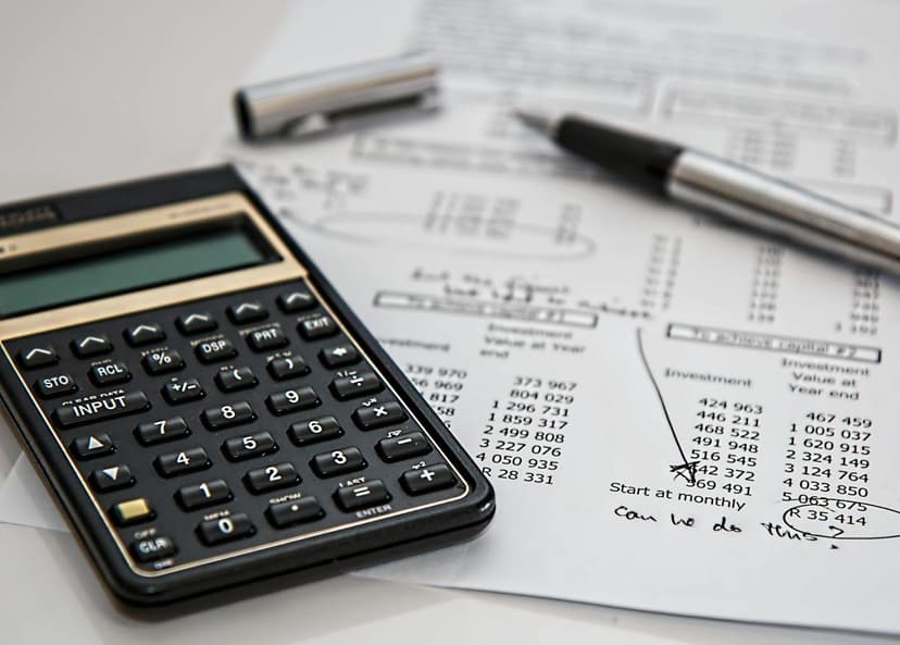A calculator on top of a financial account sheet