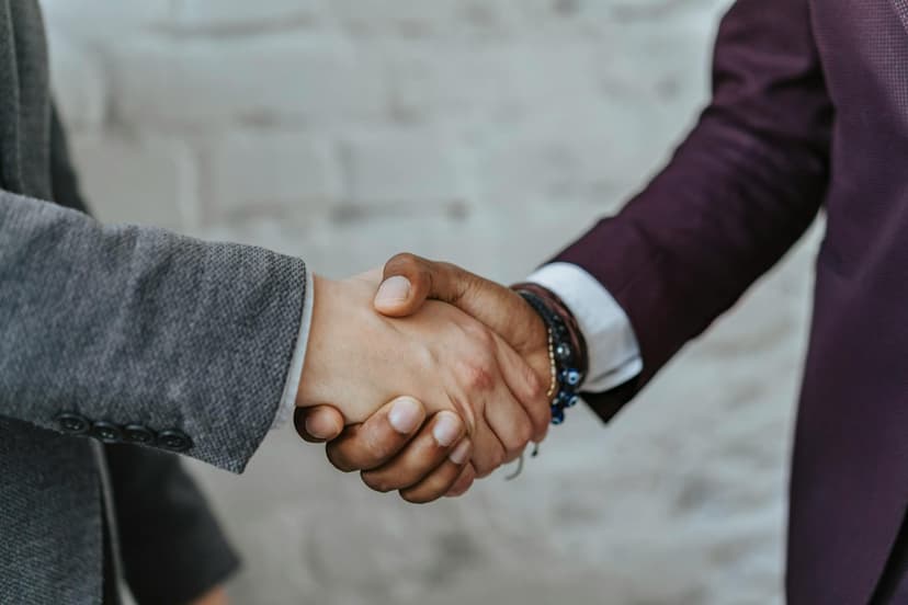 Two men shake hands